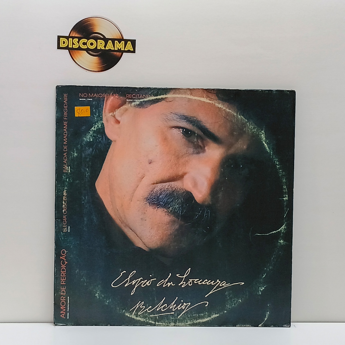BELCHIOR  -  ELOGIO DA LOUCURA  -  POSSUI ENCARTE  -  ASPECTO DO DISCO: EXCELENTE  /  ASPECTO DA CAPA: VG/VG+ (POSSUI RINGWEAR)  -  1988  -  LP DISCO DE VINIL (Verifique com atenção as imagens deste lote e entre em ...