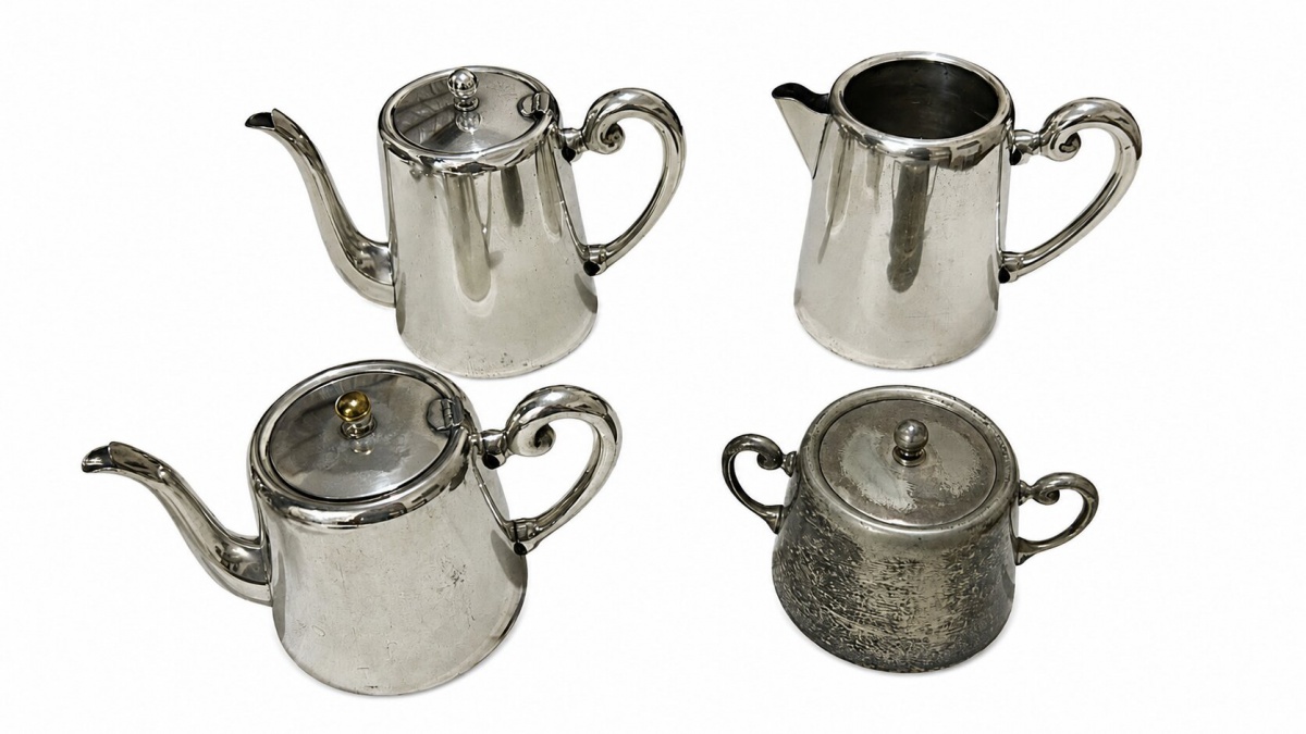 Antigo conjunto de chá, contando com bules, leiteira e açucareiro, cujos itens são elaborados em metal espessurado a prata (prata Wolff).
