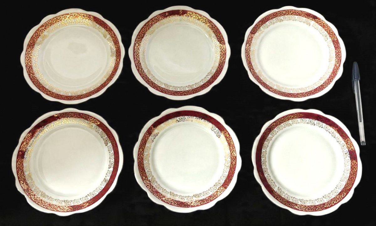 RENNER- Lote contendo 6 pratos para sobremesa, produzidas em porcelana, com ornamentação de faixa vinho, com detalhes estilizado no formato de flor em filetação de ouro, maior comprimento:18cm diâmetro.