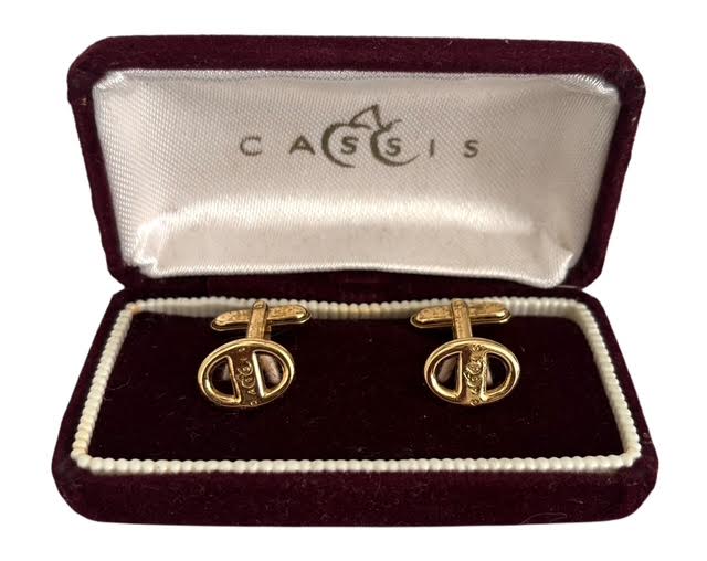 CASSIS - Par de abotoaduras em metal dourado, acondicionadas em embalagem original. Mede 9 x 5cm.