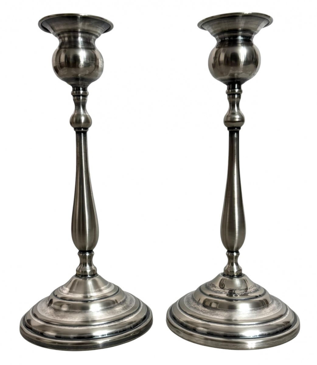 Par de castiçais em metal espessurado a prata, de elegante desenho torneado e base circular escalonada. Marca Cristofoli Prata 90 na base. Peças de linhas clássicas e refinado acabamento. Mede 24cm de altura.