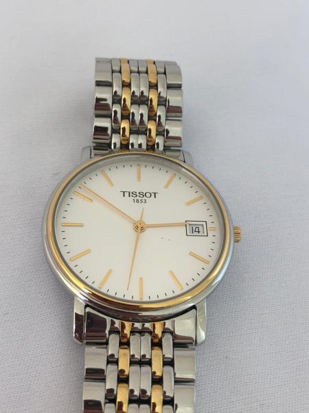 Rel gio Tissot em a o e plaqu de ouro. caixa 34mm. Movimento