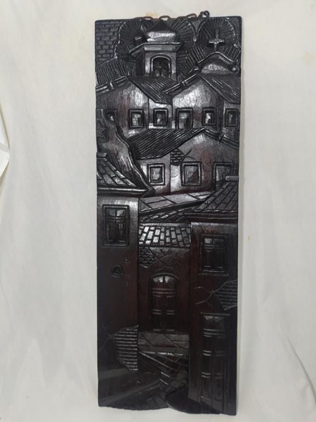 Imponente talha em madeira esculpida à mão representando casario, peça assinada e medindo 89x29cm.