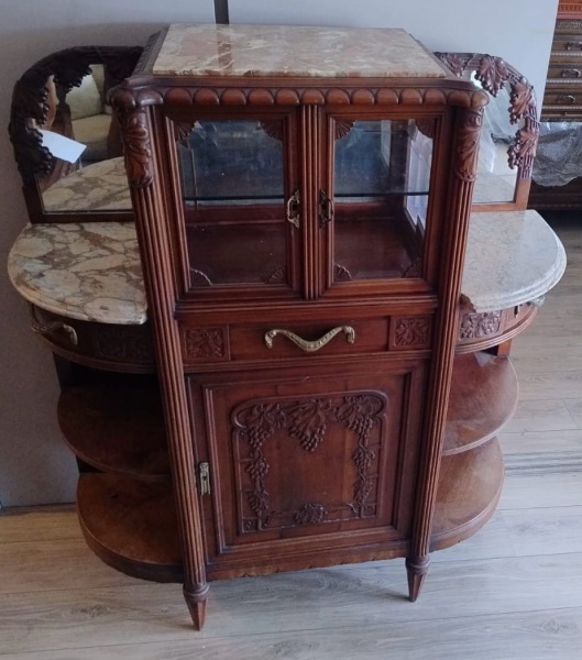 BELA VITRINE ART  NOVEAU FRANCESA EM MOGNO CENTRO EM VIDROS BISOTADOS PEQUENO PUXADOR EM BRONZE PORTA INFERIOR COM PRATELEIRA DECORADA COM PARREIRAS DE UVA LATERAIS BOMBE COM DUAS GAVETAS DUAS PRATELEIRAS ENCIMADO POR MARMORE ESPELHO NAS LATERAIS COM PARREIRAS DE UVA .
