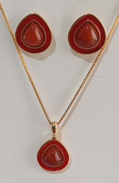 ÁGATA - Conjunto de brinco, pingente e corrente. Pedra cabochão, no formato de gota 8,6 mm. Pingente de mesma pedra. Corrente veneziana de 43cm + 7cm de extensor. Possui detalhes esmaltados em vermelho. Altura total do brinco: 1,6 cm. Altura total do pingente: 2 cm. Ágata simboliza  ura, força protetora, reforça amizade e harmonia.
