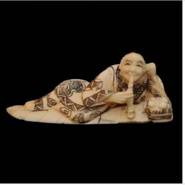 Antiguidades . Netsuke HOMEM DEITADO SOBRE FOLHA FUMANDO CACHIMBO. Medindo    6 x 2 x 2.5 cm  ...