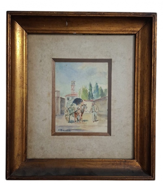Aquarela original assinada "E. Monacelli", emoldurada com passe-partout duplo e moldura dourada clássica. Cena de rua europeia, provavelmente Itália. Carroça puxada por cavalo, homem de chapéu, casari