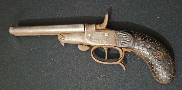 Antiga garrucha com 2 canos, produzida em aço, no estado, final do séc. XIX, não atira, apresenta ferrugem do tempo, empunhadura em metal sintético com decoração geométrica. Med. 21cm .
