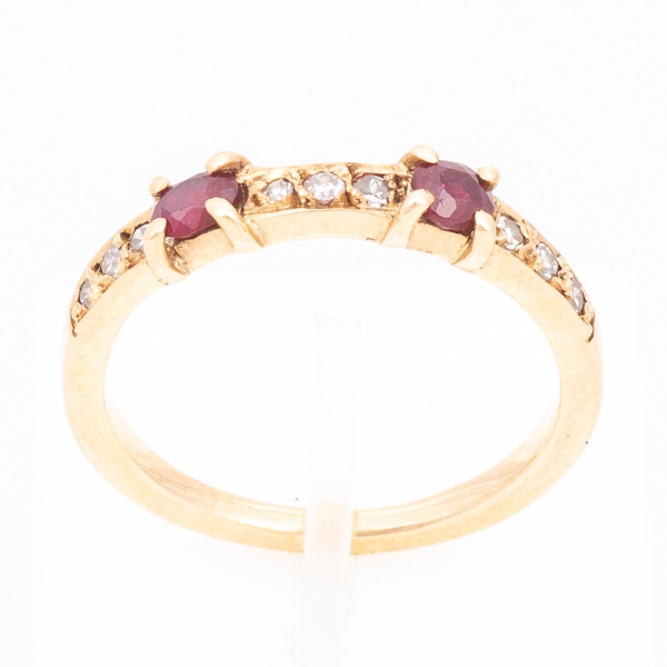Meia aliança em ouro amarelo, 18 K, cravejado de nove diamantes e dois rubis de aproximadamente 10 pontos cada. Aro 16. Peso 2,8 gr. (Por medida de segurança esse lote não se encontra em nossa loja).