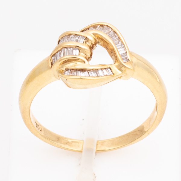 Anel em ouro amarelo contrastado 750 K, cravejado com diamantes lapidação baguete de aproximadamente 1 ponto cada. Aro 17. Peso 3,6 gr. (Por medida de segurança esse lote não se encontra em nossa loja