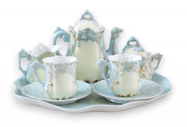 Conjunto para café em porcelana decorada em relevo floral, composto por bandeja, bule com tampa, açucareiro com tampa, leiteira, 2 xícaras e 2 pires. Peças em tons de azul e creme com detalhes dourado