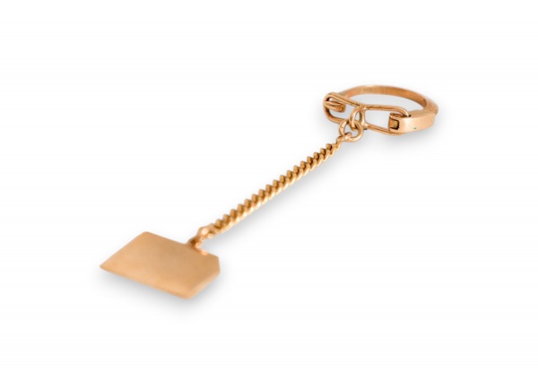 Chaveiro em ouro 18K composto por argola oval articulada tipo mosquetão, corrente de elos tipo grumet (curb), e pingente em formato de placa poligonal lisa (escudo/losango), sem gravação aparente na f