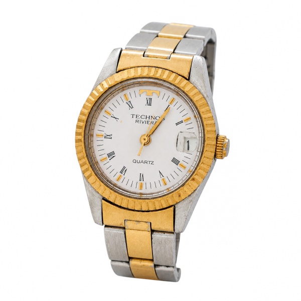 Relógio de pulso Technos Riviera Quartz, em aço bicolor, mostrador branco com algarismos romanos, calendário e pulseira metálica. Diâmetro da caixa: 26 mm. Não testado. Apresenta marcas de uso e desga