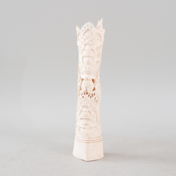 Escultura tailandesa em osso finamente entalhado, representando entidade mitológica em composição vazada com rica profusão de figuras e ornamentos, evidenciando delicado trabalho escultórico de alta m