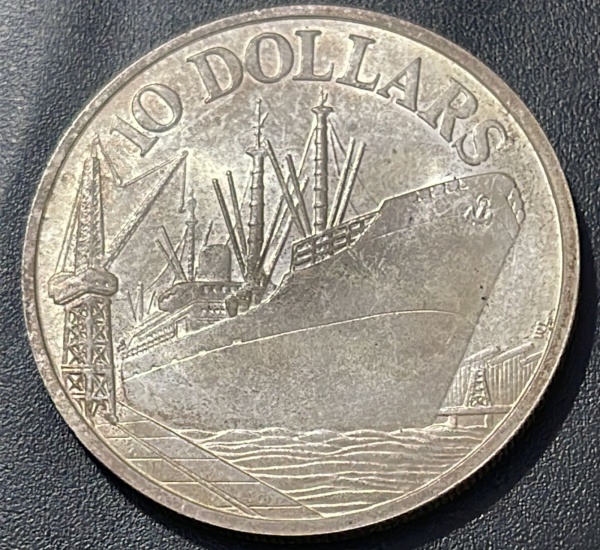 MOEDA DE SINGAPURA - 10 DOLLARS 1977 (COMEMORATIVA DOS 10 ANOS DE INDEPENDENCIA) - PRATA .500% - DIAMETRO (+/-): 40mm.