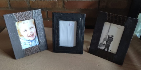Lote 67 Três porta-retratos com revestimento em couro nas molduras. Valor inicial: R$ 20,00