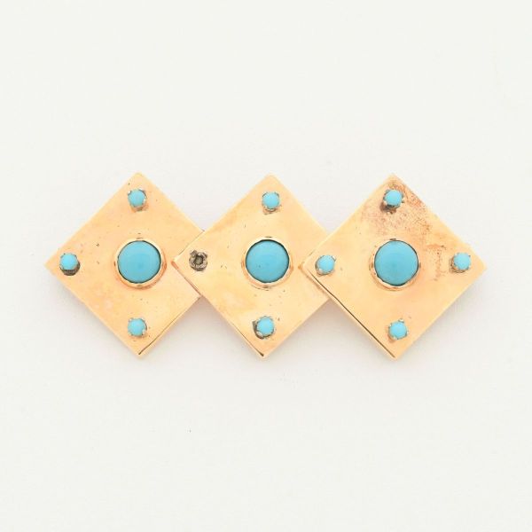 Broche em ouro amarelo 18 k, modelo tres losangos, cravejados com turquesas (ausência de uma). Medida 5,5 x 2,4 cm. Peso total 11,8 g.