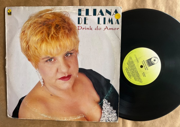 LP: Artista: Eliana de Lima / Album: Drink do Amor | Selo: JWC discos | Cód: 401 034Capa (VG): Muito Bom: marcas superficiais, com detalhes visuais; pode conter leve rasura como um nome. Vinil (VG +):