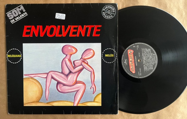LP: Artista: Som Valente / Album: Envolvente, coletânea | Selo: Mercury | Cód: 816 354Capa (VG): Muito Bom: marcas superficiais, com detalhes visuais; pode conter leve rasura como um nome. Vinil (VG +
