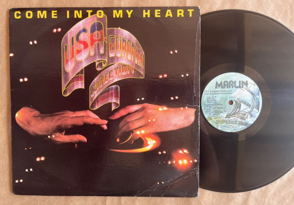 LP: Artista: Usa European Connection / Album: Come into my heart | Selo: Marlin | Cód: M-2212Capa (VG): Muito Bom: marcas superficiais, com detalhes visuais; pode conter leve rasura como um nome. Vini