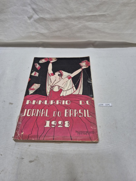 Annuário do Jornal do Brasil 1928, exemplar histórico com capa ilustrada por Palhano de Jesus, contendo registros, crônicas e publicidades da época.