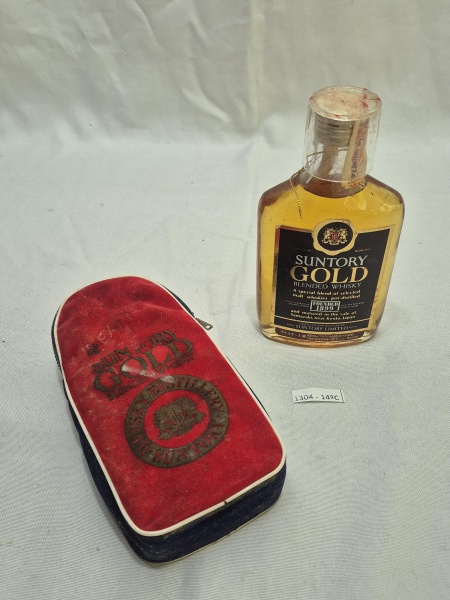Mini garrafa do Whisky dec 70 japonês Suntory Gold acompanhado de estojo em veludo e copo em plástico duro. A garrafa está lacrada, porém o liquido aparenta estar evaporado.