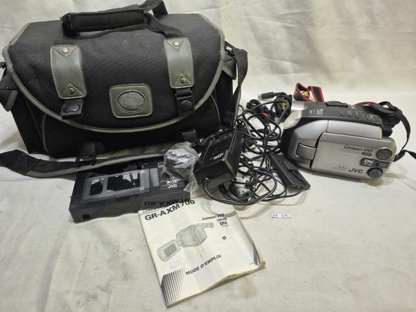 Filmadora JVC Compact VHS modelo GR-AXM700U fabricada em junho de 1998, acompanhada de bolsa de transporte, carregador, cabos, manual de instruções e adaptador de fita VHS-C. Sem a bateria, não testad