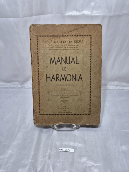 Livro antigo "Manual de Harmonia", de José Paulo da Silva, 4ª edição corrigida (1954), capa brochura, apresentando amarelamento natural do tempo, marcas de oxidação e desgastes nas extremidades.