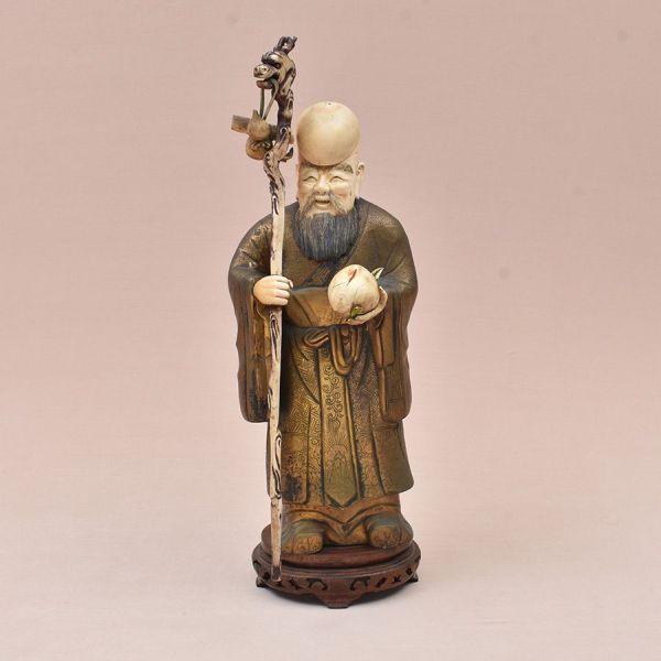 Belíssima e imponente escultura chinesa em bronze e marfim, século XIX, representando Shou Xing (Deus da Longevidade). Divindade taoísta da longevidade, identificável por sua característica testa alon