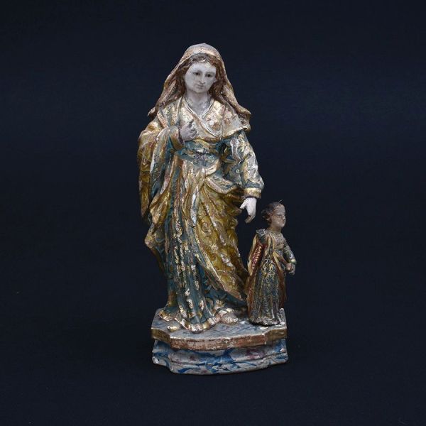 Bahia – sec. XVIII/XIX. Imagem representando Santa Ana Mestra e Nossa Senhora, entalhada em madeira, dourada e policromada. Exemplar representando o modelo dito caminhante de santa Ana, em que ambas a