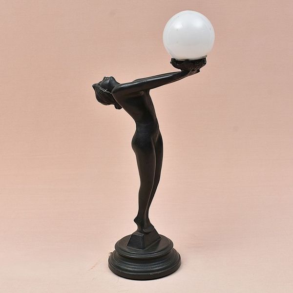 Escultura luminária europeia em petit bronze estilo Art Deco representando figura de nu feminino segurando globo de luz. Alt. 55 cm. (restauro na altura da cintura)