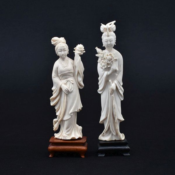 Par de estatuetas de marfim chinês cerca de 1940 representado figuras de damas. Base de madeira. Alt. total 20 e 18 cm.