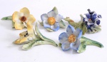 Cinco enfeites de mesa em porcelana decoração com flores e galhos.