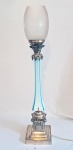 Grande luminária europeia, cerca de 1900, com haste em opalina branca e azul, guarnição em metal espessurado a prata e cúpula em vidro lapidado satinê no formato de ogiva. funcionando. Altura: 73 cm.