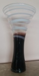  Bertalocci  Belíssima Floreira em vidro de Murano, base - na cor marrom, e parte superior -    transparente (Listras giratórias tranversais brancas), altura 50 cm. Assinada.