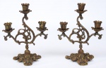 BRONZE - Lindo par de castiçais em bronze, ricamente cinzelado com decoração de volutas. Med.: 26x20x13 cm