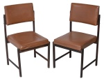 DESIGN - Lote constando duas cadeiras anos 60 em jacarandá com delicado acabamento, acento e encosto em couro ecológico. Madeira em perfeito estado.  Med.: 85x48x47. OBS: parte  de trás do estofamento de uma cadeira está solto.