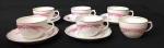Real - 6 xícaras com 5 pires em porcelana nacional para café na cor branca com decoração de trigos na cor rosa. Medida xícara 6 x 4 cm e pires 10 cm.