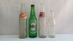 Lote Composto de 4 Garrafas Colecionáveis: FANTA, PEPSI, SUKITA e HEINEKEN; aprox. 24 x 6cm, garrafas em vidro, vazias, com marcas do tempo