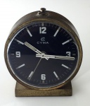 Relógio Despertador Cyma pequeno, movimento a corda, caixa de bronze de 50 mm de diâmetro, mostrador preto, em perfeito estado