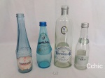 Lote 4 garrafas de água em vidro de diversos modelos e pais.