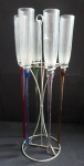 Cinco flutes de vidro Murano transparente  para espumante com bases  coloridas 5 cores diferentes, acompanha suporte de metal prateado. Alt 47cm.