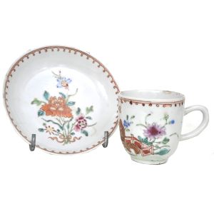 Xícara com pires em porcelana chinesa nos esmaltes da família rosa, com fina pintura de peônia, ramos e folhas. Período Qianlong(1736-1795). Diâmetro: 12 cm(trinca na ponta da alça)