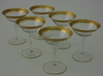 Seis taças para champagne em cristal europeio, com guarda em ouro. Altura  11 cm.