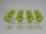 Doze taças de cristal Saint Louis francês, cor verde com decoração a ouro, altura 13 cm.