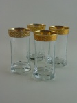 Quatro copos de cristal com decoração a ouro. Altura 14 cm.