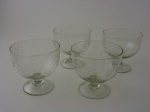 Quatro cremeiras de cristal decoradas, altura 11,5 cm.