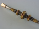 Bomba para chimarrão em prata 600 com decoração em ouro e nove rubis, comprimento 34 cm.