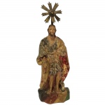 Escultura em madeira representando São João Batista com resplendor em latão. Brasil, Séc XIX. 30 cm com resplendor e 24 cm sem.