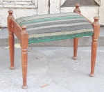 Banqueta em madeira torneada com estofado.